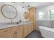 Bright bathroom featuring double sinks, granite countertop, tub and cabinet at 3155 Zion St, Scottdale, GA 30079