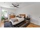 Bedroom with hardwood floors, a modern ceiling fan, and large windows at 3155 Zion St, Scottdale, GA 30079