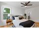 Cozy bedroom featuring hardwood floors, ceiling fan, and natural light with a view of backyard at 3155 Zion St, Scottdale, GA 30079
