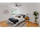 Bright bedroom with hardwood floors, ceiling fan, stylish rug, and natural light from the window at 3155 Zion St, Scottdale, GA 30079