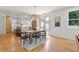 Open dining room with hardwood floors, modern lighting, and view of the kitchen at 3155 Zion St, Scottdale, GA 30079