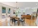 Open dining area features hardwood floors, stylish lighting, and access to outdoor space at 3155 Zion St, Scottdale, GA 30079