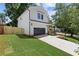 Side view of a modern farmhouse style home with green grass and a partial view of a wood fence at 3155 Zion St, Scottdale, GA 30079