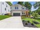 Charming two-story home featuring a modern farmhouse design, landscaped yard and a wide driveway at 3155 Zion St, Scottdale, GA 30079
