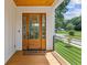 Charming porch view featuring a wooden front door with glass panels and a welcoming doormat at 3155 Zion St, Scottdale, GA 30079