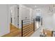 Upstairs hallway with a railing and hardwood floors at 3155 Zion St, Scottdale, GA 30079
