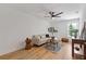 Living room with hardwood floors, a neutral color scheme, and a ceiling fan at 3155 Zion St, Scottdale, GA 30079