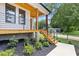 Inviting porch with wood ceiling, metal railings and stylish staircase leading to the entrance at 3155 Zion St, Scottdale, GA 30079