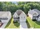 Beautiful home with a two-car garage, landscaped front yard, and a driveway for extra parking at 4420 Ambassador Way, Cumming, GA 30040
