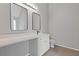 Bathroom features an extended vanity with quartz countertop and modern rectangle mirrors for ample space at 4420 Ambassador Way, Cumming, GA 30040