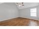 A neutral bedroom featuring hardwood floors, a ceiling fan and large windows for natural light at 4420 Ambassador Way, Cumming, GA 30040