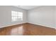 Neutral bedroom featuring hardwood floors and a bright window, ideal for relaxation at 4420 Ambassador Way, Cumming, GA 30040