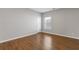 Cozy bedroom featuring hardwood floors, neutral walls, and a bright window at 4420 Ambassador Way, Cumming, GA 30040