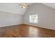 Bedroom with hardwood flooring, vaulted ceilings, ceiling fan, and bright window, offering ample light at 4420 Ambassador Way, Cumming, GA 30040