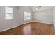 Bedroom featuring hardwood flooring, ceiling fan, and natural light with large windows at 4420 Ambassador Way, Cumming, GA 30040
