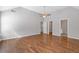 Large bedroom showcasing hardwood floors, a ceiling fan, with multiple rooms leading from the space at 4420 Ambassador Way, Cumming, GA 30040