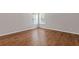This bedroom boasts gleaming hardwood floors and plenty of natural light with two bright windows at 4420 Ambassador Way, Cumming, GA 30040