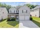 Charming two-story home with stone accents, well-maintained lawn, and a two-car garage at 4420 Ambassador Way, Cumming, GA 30040