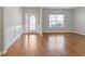 Bright living room with hardwood floors, white trim, and a window with natural light at 4420 Ambassador Way, Cumming, GA 30040