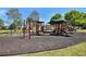 Community playground features swings, slides, and climbing structures on a safe, rubber mulch surface for to enjoy outdoor activities at 4420 Ambassador Way, Cumming, GA 30040