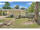 Exterior home showing a small yard area with an outbuilding and trash cans at 1667 Sylvan Sw Rd, Atlanta, GA 30310