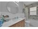 Bright bathroom with updated sink, vanity, and shower with attractive tile surround at 1667 Sylvan Sw Rd, Atlanta, GA 30310