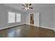 Spacious bedroom with large windows allowing ample natural light and dark hardwood flooring at 1667 Sylvan Sw Rd, Atlanta, GA 30310