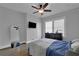 Comfortable bedroom features hardwood floors, ceiling fan, and large mirror at 1667 Sylvan Sw Rd, Atlanta, GA 30310