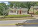 Charming bungalow with a red front door, lovely front porch, and freshly landscaped lawn at 1667 Sylvan Sw Rd, Atlanta, GA 30310