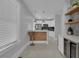 Charming kitchen featuring modern appliances, white cabinets, and a breakfast bar for casual dining at 1667 Sylvan Sw Rd, Atlanta, GA 30310