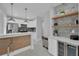 Modern kitchen features stainless steel appliances, a breakfast bar, and open shelving for storage and decor at 1667 Sylvan Sw Rd, Atlanta, GA 30310