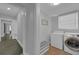Convenient laundry room with washer, dryer, and storage space for cleaning supplies at 1667 Sylvan Sw Rd, Atlanta, GA 30310