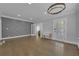 Open-concept living room with hardwood floors, custom wall trim, and modern lighting fixtures at 1667 Sylvan Sw Rd, Atlanta, GA 30310