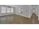Spacious living area with hardwood floors, bright windows, and an open doorway leading to other rooms at 1667 Sylvan Sw Rd, Atlanta, GA 30310