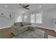 Bright living room with hardwood floors, neutral paint, and a plush sectional sofa for comfortable seating at 1667 Sylvan Sw Rd, Atlanta, GA 30310