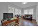 Well-lit home office with hardwood floors, a work desk, and comfortable seating for a productive workspace at 1667 Sylvan Sw Rd, Atlanta, GA 30310
