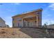 Home's exterior showcases a covered patio, complemented by a spacious backyard ideal for relaxation and entertainment at 213 Ruthe Cv, Locust Grove, GA 30248