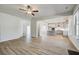 Open-concept living area featuring a fireplace with views into the modern kitchen at 213 Ruthe Cv, Locust Grove, GA 30248