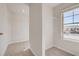 Bright walk-in closet with carpeted floors, wire shelving, and a window with neighborhood view at 213 Ruthe Cv, Locust Grove, GA 30248