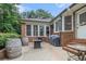 Charming brick patio with an outdoor grill, a fire pit, two wooden barrel decorations, and access to the home's backyard at 3003 Hanover Se Ln, Conyers, GA 30094
