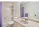 Bathroom featuring a granite-style countertop with a sink, a large mirror, and a shower-tub combination with purple curtain at 3003 Hanover Se Ln, Conyers, GA 30094