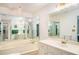 Spacious bathroom features a jacuzzi tub, dual sink vanity, and multiple mirrors at 3003 Hanover Se Ln, Conyers, GA 30094