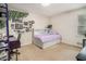 A cozy bedroom with neutral carpeting, a window, and a unique bed frame that includes built-in storage and shelving at 3003 Hanover Se Ln, Conyers, GA 30094