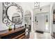 Inviting foyer with tiled floors, arched doorways, and a decorative mirror creating an elegant entrance at 3003 Hanover Se Ln, Conyers, GA 30094