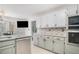 Bright kitchen with granite countertops, tile backsplash, and stainless steel appliances at 3003 Hanover Se Ln, Conyers, GA 30094