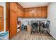 Well-organized laundry room with plenty of cabinet space, modern washer and dryer units, and attractive wood-look flooring at 3003 Hanover Se Ln, Conyers, GA 30094