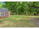 Extensive backyard with lush green lawn and mature trees, providing a serene and private outdoor space at 365 Norcross St, Roswell, GA 30075