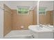 Bathroom featuring tiled walls, shower, and sink with vanity and large mirror at 365 Norcross St, Roswell, GA 30075