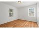 Bedroom featuring hardwood floors and natural light from two windows at 365 Norcross St, Roswell, GA 30075