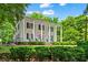 Charming two-story home with a classic facade, inviting front porch, and lush landscaped yard at 365 Norcross St, Roswell, GA 30075